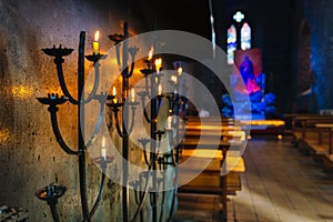 Selective focus on votive lit candle on candelabra in St Marys Cathedral