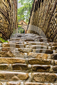 Selective focus, wet stone stairs and stone arch after rain. Monastery of St. Nino at Bodbe, Georgia