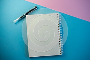selective focus, white blank Notepad under copyspace, on colored background