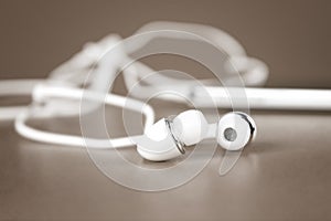 Selective focus of white earphones for using with digital music