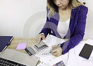 Asian woman hand with pen  check calculating her monthly of debt bills bank papers expenses and payment