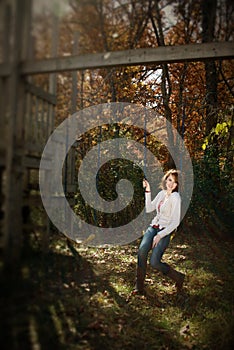 Selective Focus of woman on swing, autumn