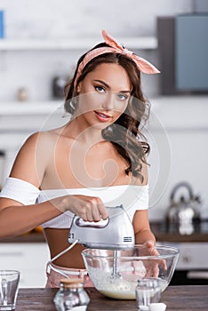 Selective focus of woman using mixer