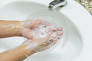 Selective focus of woman washing hands with soap