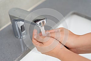 Selective focus of woman washing hands with soap