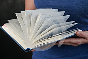 selective focus, women& x27;s hands holding an open book