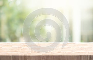 Selective focus.Wood table counter on blur green garden garden from window view background