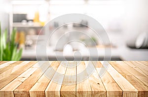 Selective focus.Wood table top on blur kitchen counter background.For montage product display or design key visual layout