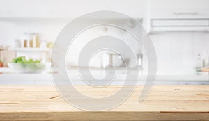 Selective focus.Wood table top on blur kitchen counter in morning background.For montage product display or design key visual