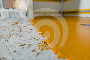 Selective focus on the yellow floor of freshly applied epoxy mortar system