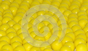 Selective focus of yellow round dragees of ascorbic acid vitamin C