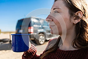 Young woman drinking coffee or tea