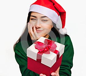 Selective focus Young beautiful asian woman wore green sweater and santa hat,Excited, surprised and happy, Holding a gift box with