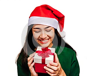 Selective focus Young beautiful asian woman wore green sweater and santa hat,Excited, surprised and happy, Holding a gift box with