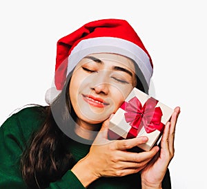 Selective focus Young beautiful asian woman wore green sweater and santa hat,Excited, surprised and happy, Holding a gift box with