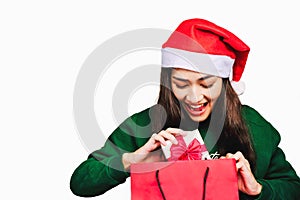 Selective focus Young beautiful asian woman wore green sweater and santa hat,Excited, surprised and happy, Holding a gift box with