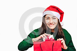 Selective focus Young beautiful asian woman wore green sweater and santa hat,Excited, surprised and happy, Holding a gift box with