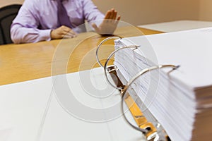 Selective focus Young business man in the office sitting in front of the folder refuse to work