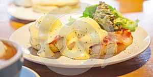 Selective Focused Eggs Benedict, a sandwich consists of 2 halves of English muffin topped with poached egg, bacon or ham and