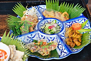 Selective focused Thailand cuisine food platter; Mi krop Traditional Thai Crispy Rice Noodles, Turmeric Fried Chicken, Herb