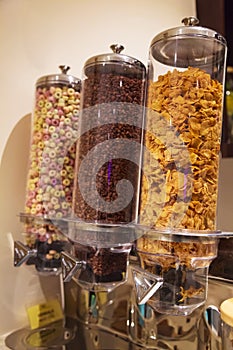 Selective Focused Variety of Breakfast Cereals Morning Meal; Crisp Dark Chocolate, Corn Flakes and Fruit Loops in Cereal Glass Jar