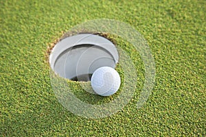Selective foucs close up of golf ball near hole on green