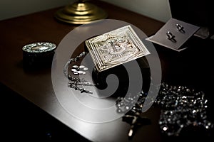 Selective shot of the holy bible, crystal  necklaces with silver crosses and a jewelry metal box photo