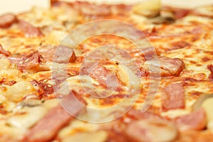 Selectived focus on ham topping on pizza background