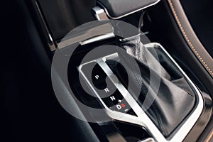 Selector automatic transmission with perforated leather in the interior of a modern expensive car