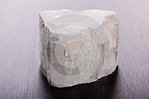 Selenite stone on wood macro photo