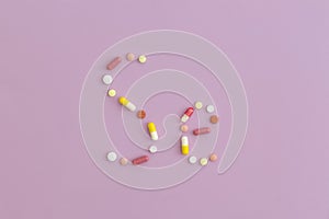 Selenium symbol made from pills on purple background. Top view with copy space. Flat lay