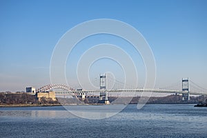 Self-anchored suspension bridge New York City evening sun setting sky