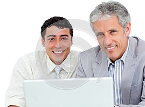 Self-assured business co-workers using a laptop photo