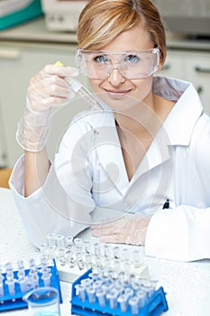 Self-assured female scientist holding samples