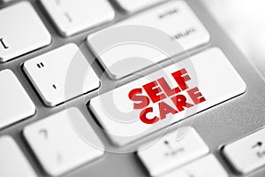 Self Care text button on keyboard, health concept background