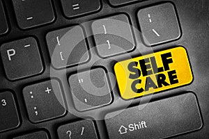 Self Care text button on keyboard, health concept background