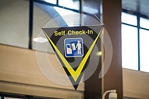 Self check-in sign inside an international airport