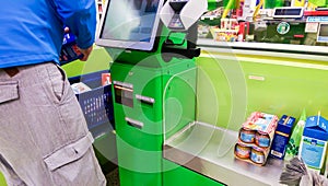 Self-checkout made by a male customer in a finnish supermarket