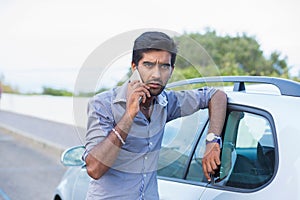Self confident handsome man young entrepreneur talking on mobile phone standing outdoors