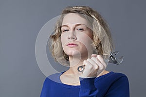 Self-confident mechanics girl holding wrench for efficient automotive repair