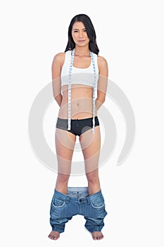 Self confident woman wearing jeans falling down because shes los