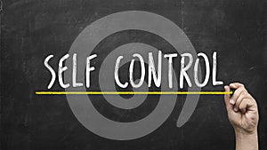 Self control concept. Hand with yellow marker writing self control inscription text on chalkboard.