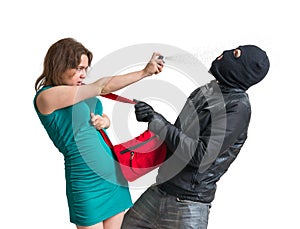 Self defense concept. Young woman is defending with pepper spray. photo