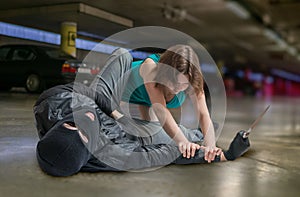 Self defense concept. Young woman is fighting with mugger or thief