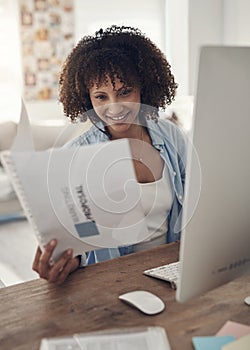 Self-educate and invest in yourself. an attractive young woman sitting alone at home and using her computer while