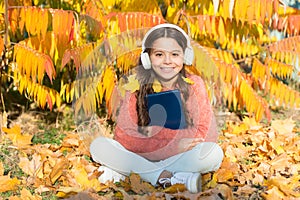 Self education concept. Child enjoy reading. Visual and audio information. Little child enjoy learning at backyard. Kid