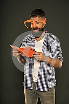 Self education concept. Literary club. Reading book as hobby. Study is fun. Hipster bearded man funny eyeglasses hold