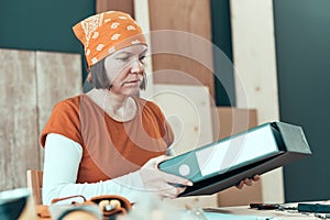 Self employed female carpenter with document ring binder