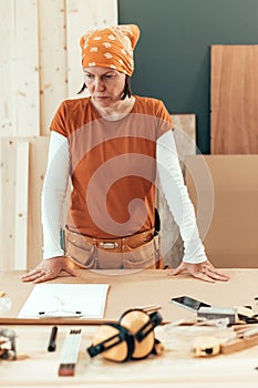 Self employed female carpenter planning DIY project