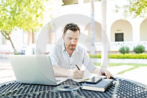 Self-Employed Man Preparing Schedule In Garden